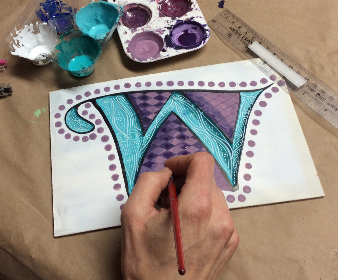 teal and purple decorated letter "w"