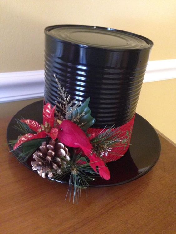 Black metal snowman hat with ribbon and greenery 