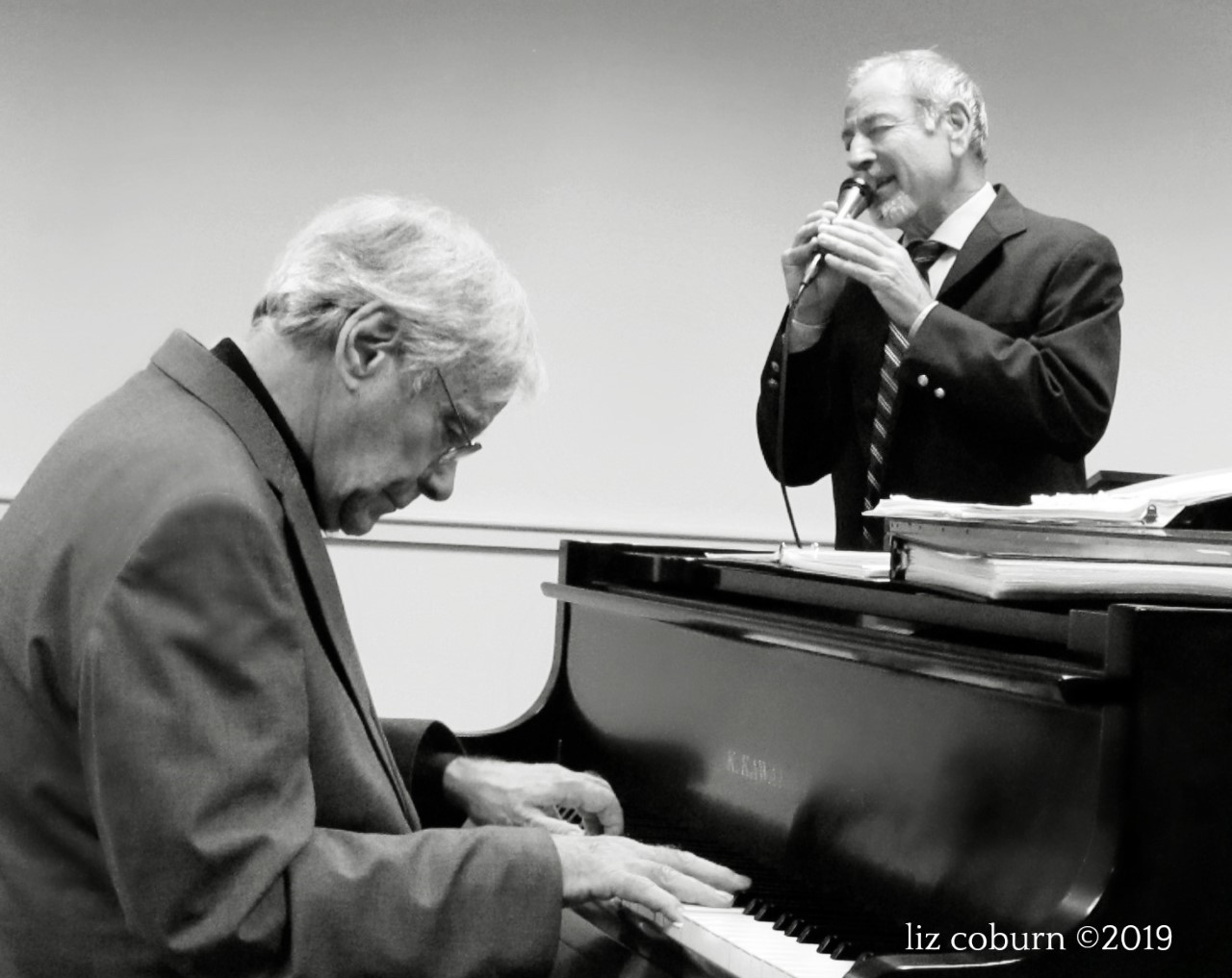 Black and white photo of musicians - John Brighenti at piano and Lou Provenzano singing 