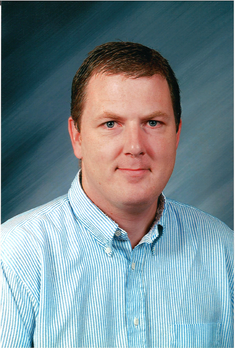 John O'Connor against a blue and black background with a light blue shirt on