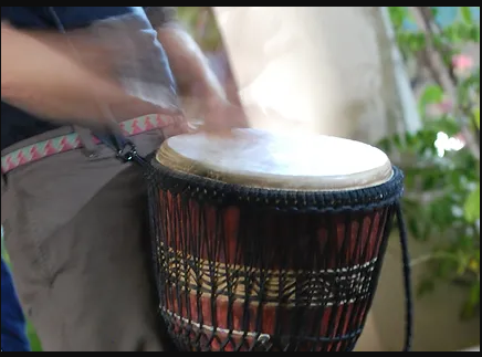 a close up photo of a person playing a drum that was taken with a fast shutter speed. 
