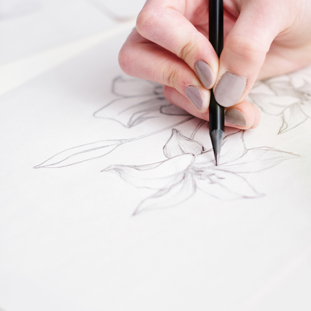 Photo of a person drawing a flower