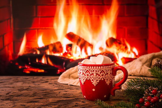 Cup of cocoa by fireplace
