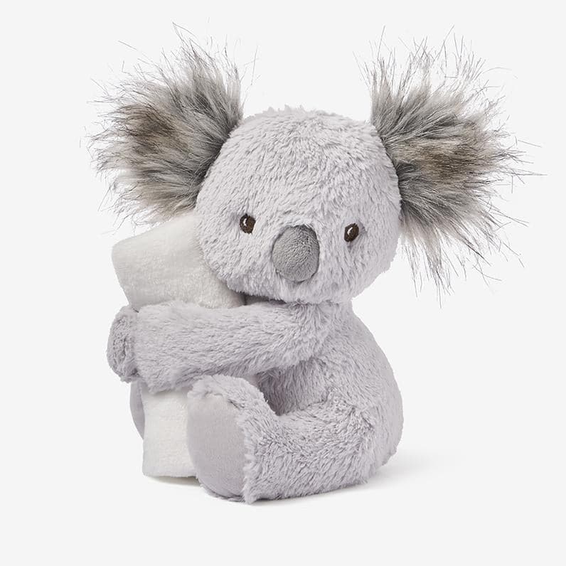 stuffed koala hugging a blanket