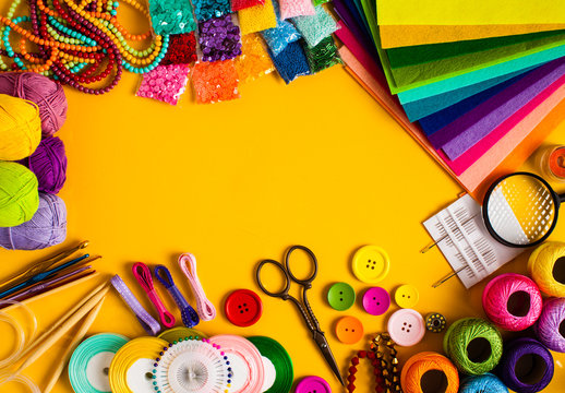 a stock image different crafting supplies over a burnt orange background