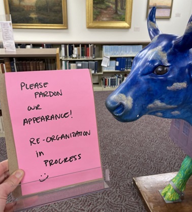 Cow and pink sign