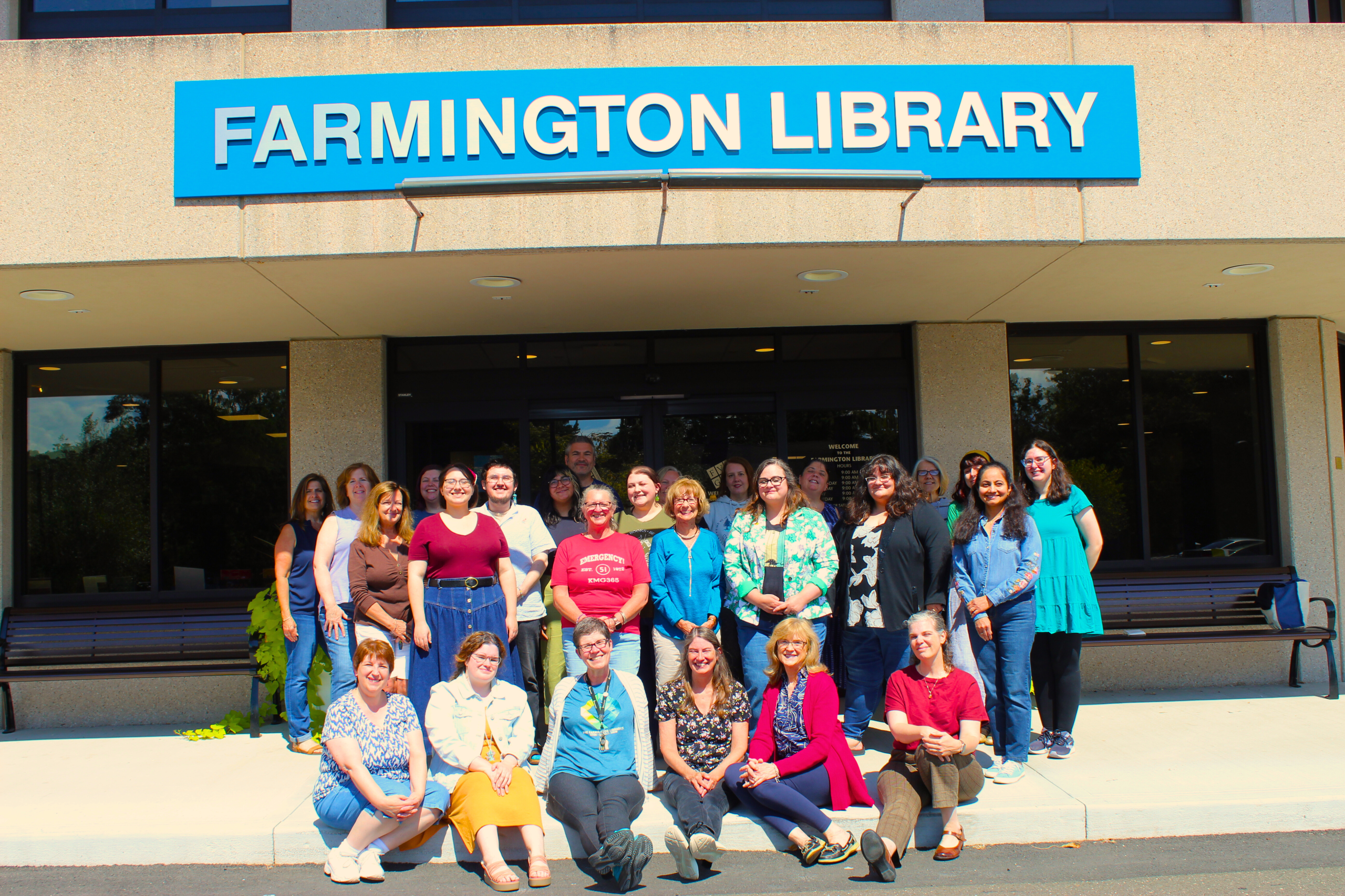 Library staff standing outside the front door of the Farmington Library in August 2025