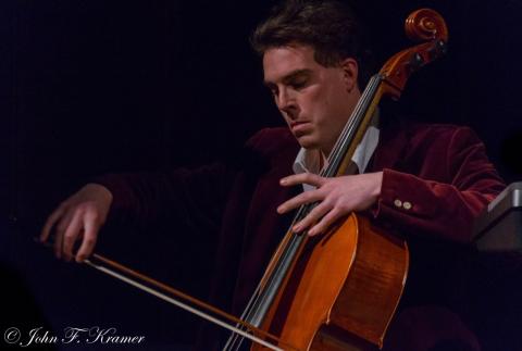 Ryan Mitten playing the Cello against a black background