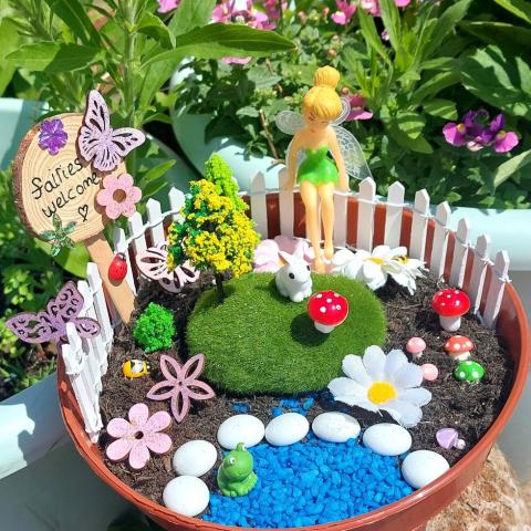 Tinkerbell diy garden with fence, mushrooms, and lake