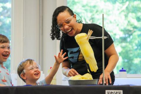 adult and 2 children doing science experiment