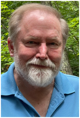 a picture of an older man against a greenery background