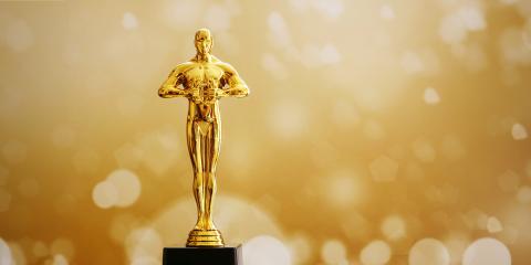 an image of a Movie Oscar award with a golden background