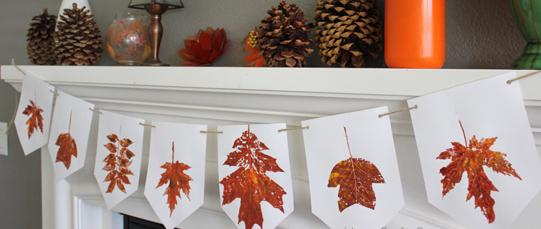 white banner on mantle with fall leaf prints